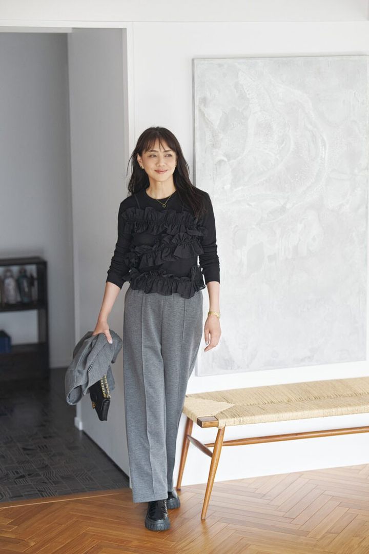 トップス／エズミ、パンツ、手に持ったジャケット／ともにミュエルシック、ピアス、ネックレス／ともにヴァンクリーフ＆アーペル、ブーツ／ノーネーム（すべて私物）