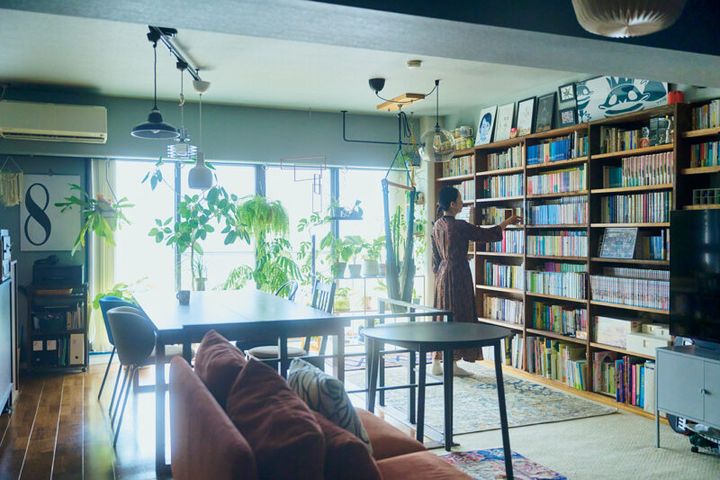 窓一面にグリーン、壁一面に本棚を配した 印象的なリビング・ダイニング