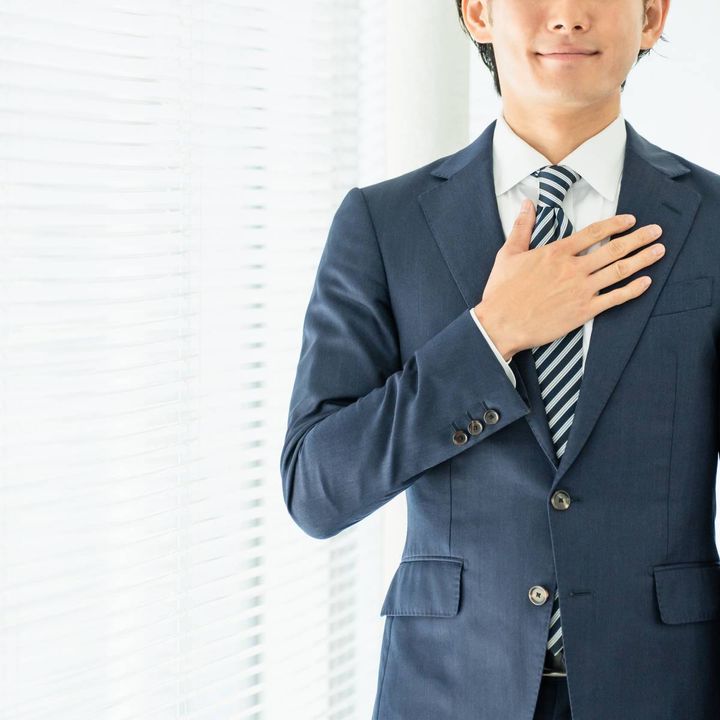 胸に手を当てる人