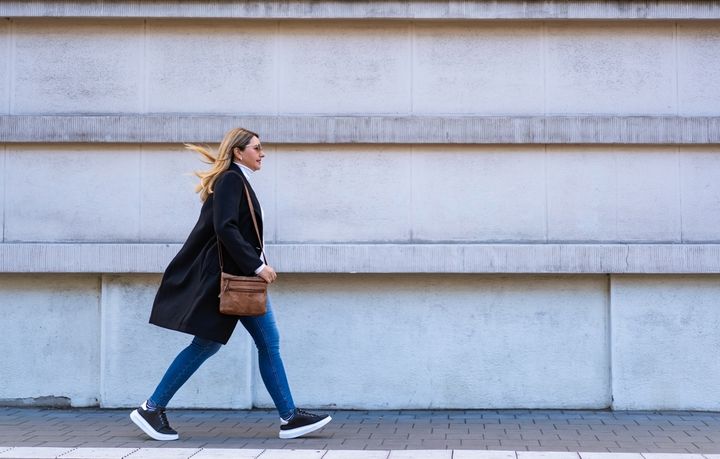 コンパクトなショルダーバッグを持ち歩く女性