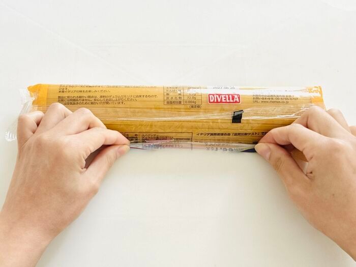 パスタの袋を巻いている