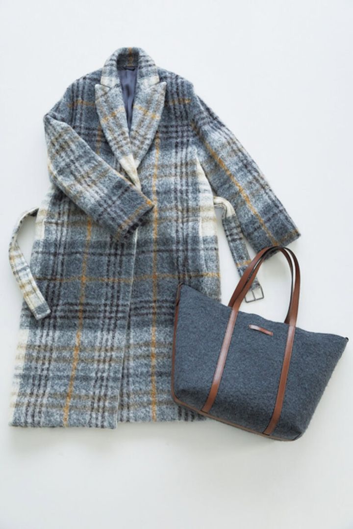 「ブルネロ クチネリ」のアルパカコートは、暖かくて合わせやすさも◎。「旅先でも重宝しています」。バッグも同ブランド。