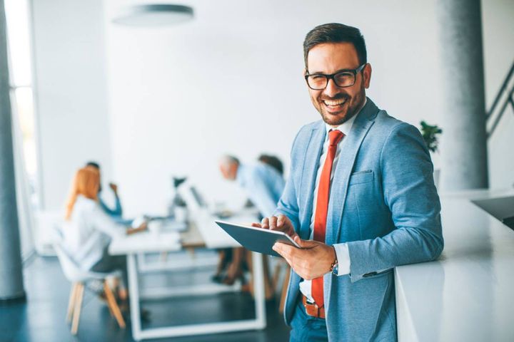 笑顔を向けるタブレットを持った男性