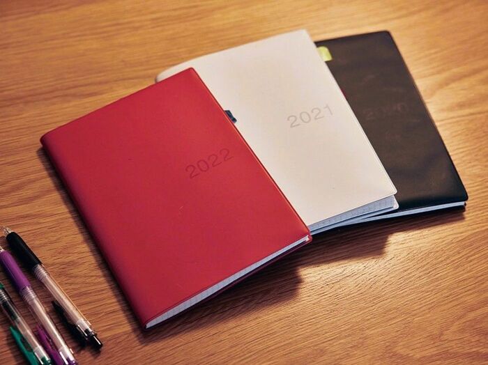 無印良品の手帳に記録された2020年・2021年・2022年の日記。毎日の出来事を綴る習慣が続く、シンプルなデザインのスケジュール帳とカラーペン。