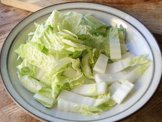 白菜は縦半分に切ってから、根元の白い茎の部分は2cm程の幅に切って皿に広げる
