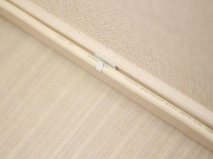 フックをコードに巻いて壁に固定