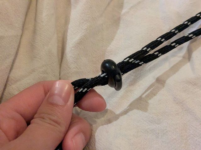 サコッシュのコードストラップのストッパー部分アップ