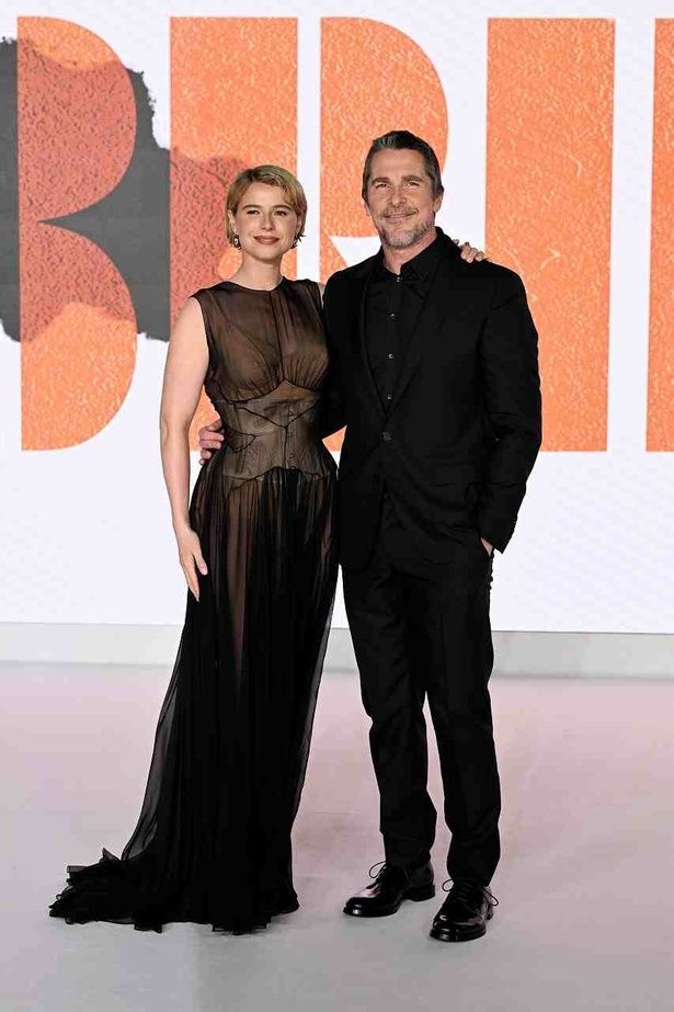 【写真を見る】シースルーの漆黒のドレスをまとったジェシー・バックリーとクリスチャン・ベールの2ショット [c]2026 Warner Bros. Entertainment Inc. All Rights Reserved.