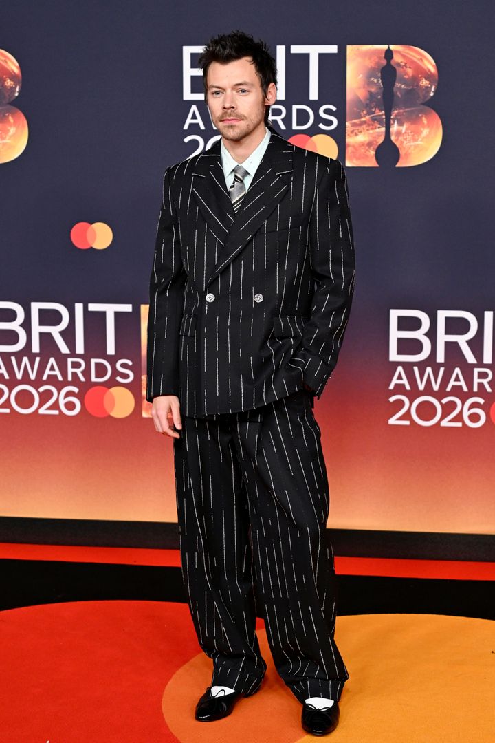 Image may contain_ Harry Styles, Clothing, Formal Wear, Suit, Fashion, Adult, Person, Coat, and Pajamas