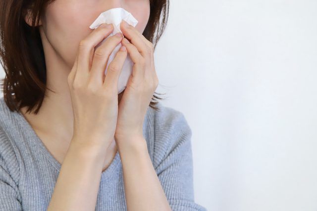 鼻をかむ女性