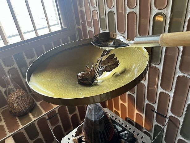 漏斗を通して水を灌ぐと、フラスコ内の水が溢れてサウナストーンにかかる