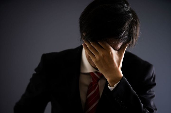 頭を抱えている男性