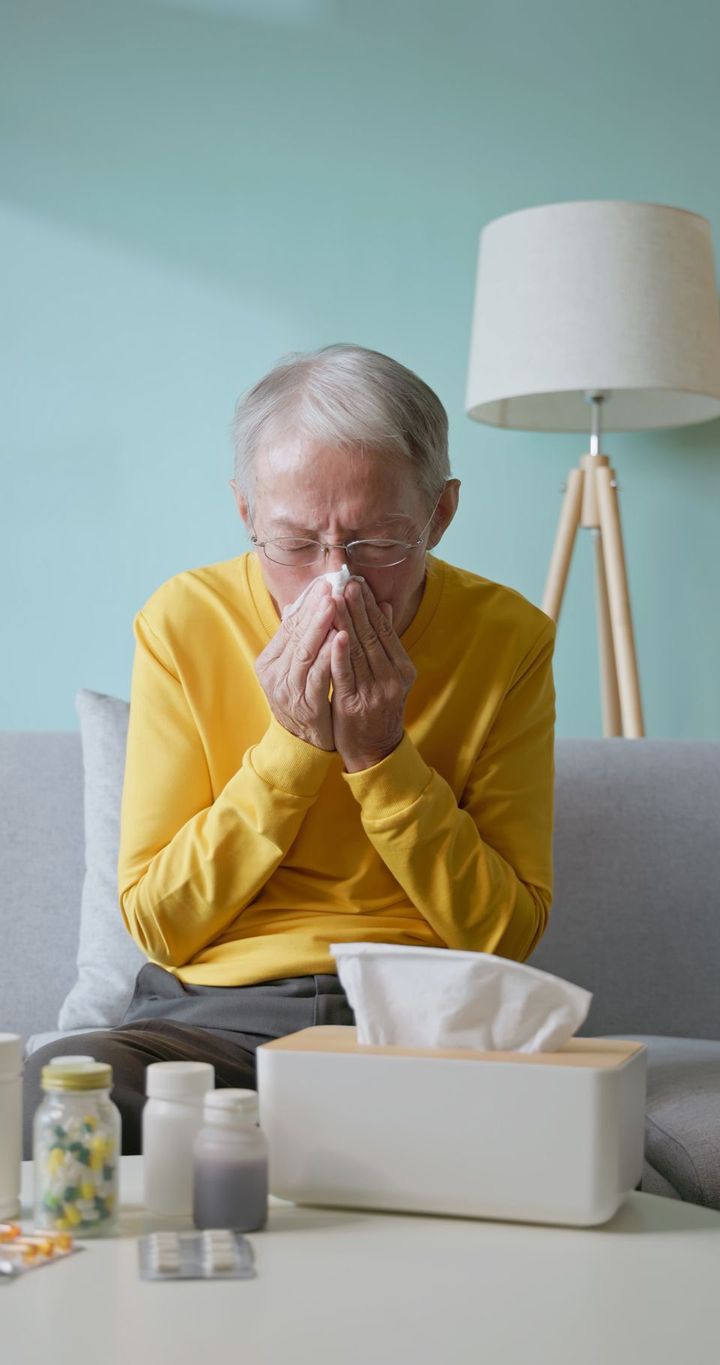 鼻をかんでいるシニア男性