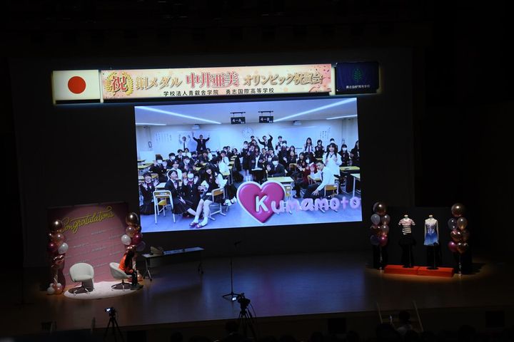 画像: 全国各地で学ぶ同級生からのビデオメッセージを見つめる。