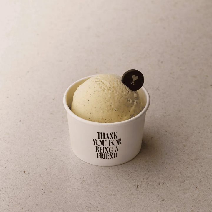 Ami Parisロゴ入りチョコレートプレートを添えたバニラアイスクリーム1スクープ、白カップに「THANK YOU FOR BEING A FRIEND」印字