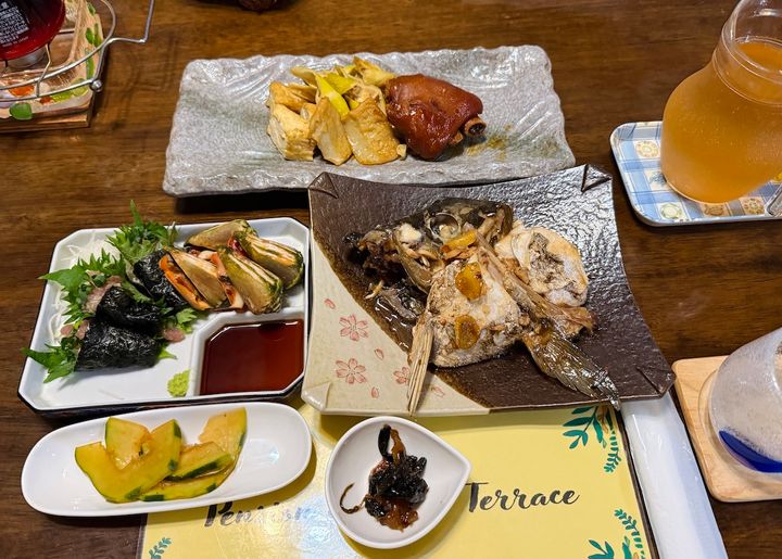 「マリンテラス」の「夕食」（3300円・要予約）。この日は島の貝「トビンニャ」や島豚の豚足、カンパチの焼き魚 など。名物「油そうめん入りのお吸い物」もセットでした ※内容は日によって異なる