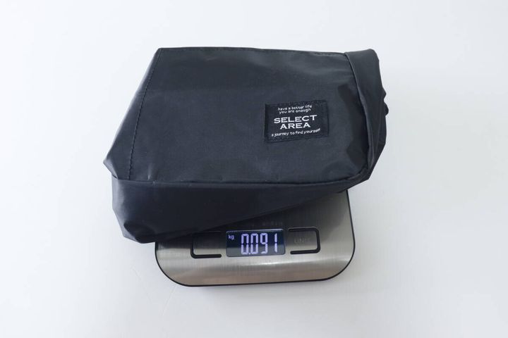 黒いショルダーバッグをキッチンスケールに乗せ91gと表示