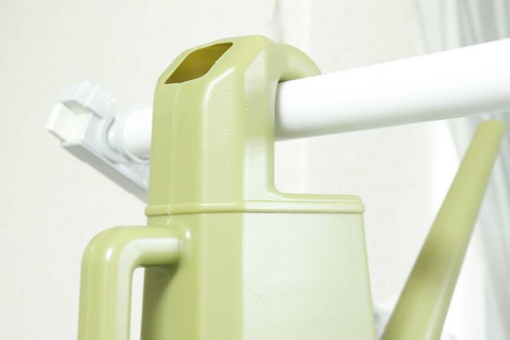 水差しのフックを白いポールに引っ掛けて収納している様子
