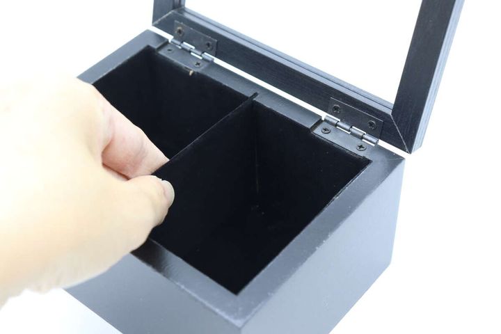 収納BOX内部の仕切り板を指で触っている様子