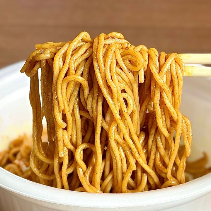 日清食品の「日清焼そばU.F.O. スパイスキーマカレー焼そば」の麺をお箸で掴む様子