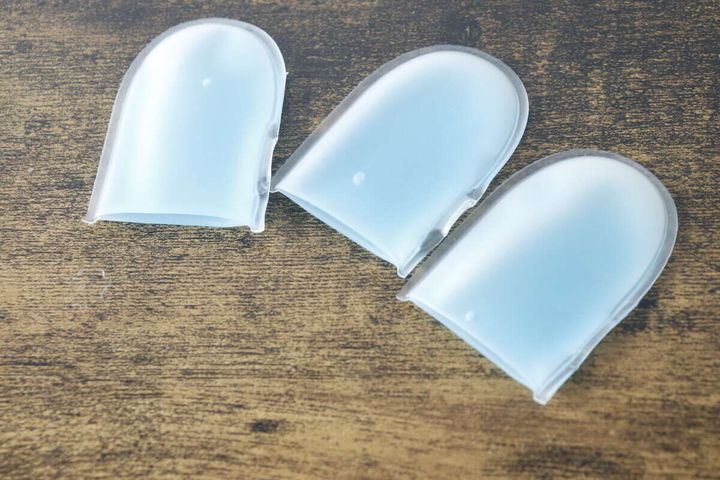 クールフィンガーの青いジェル入り指サック3個を木目調のテーブルに置いた様子