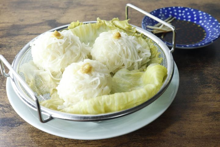 完成したシューマイが乗ったメッシュザルが皿に置かれ食卓に並ぶ