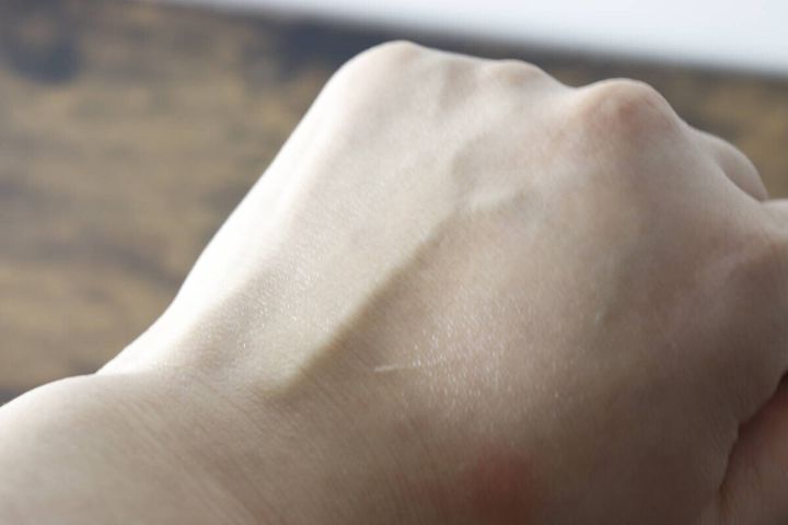 オイルを塗ってテカっている状態の女性の手の甲