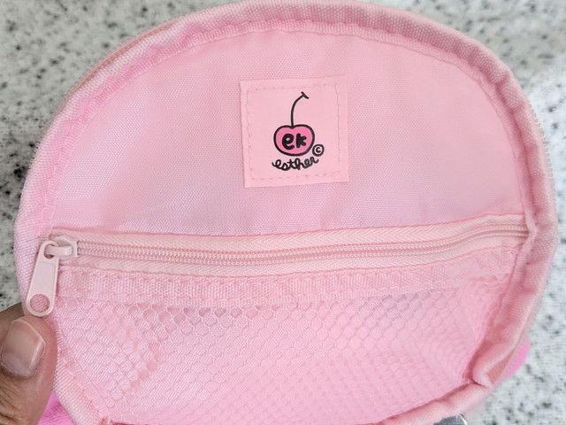 バニティポーチ内側のジップ付きメッシュポケットとブランドタグの写真