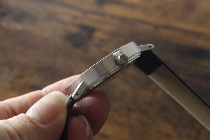 指で持ったシンプルウォッチの薄い側面
