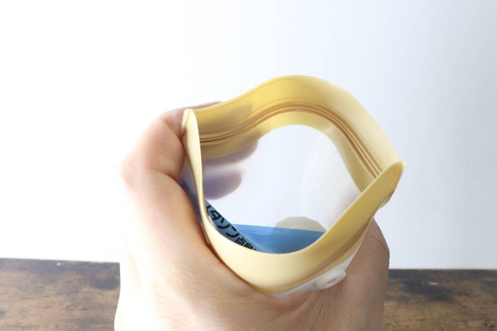 手でチャック袋の口を開きマチの広さを見せている