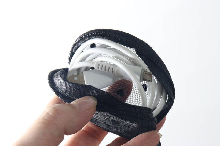 黒いメッシュポーチに白い充電ケーブルを入れた様子
