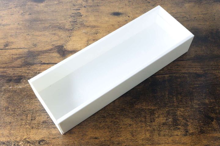 木目調のテーブルに置かれた白いキッチン伸縮ケース