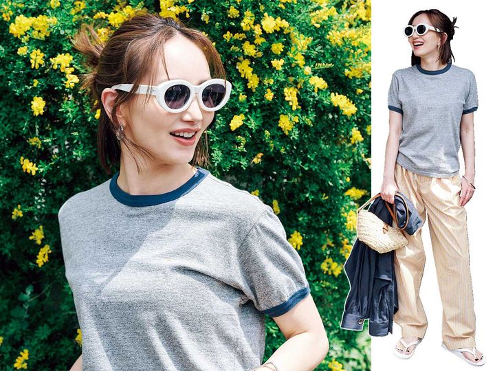 アヤメの白フレームサングラスをかけるTシャツ姿のモデル