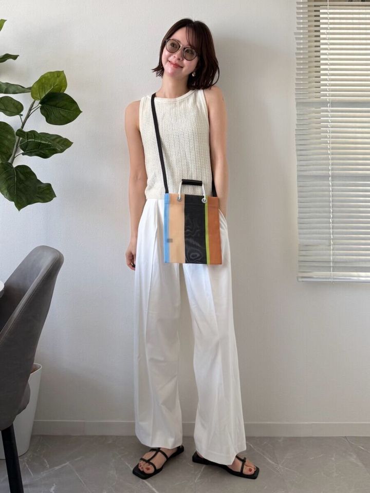 白いパンツに白いノースリーブトップスを合わせた女性の夏コーデ