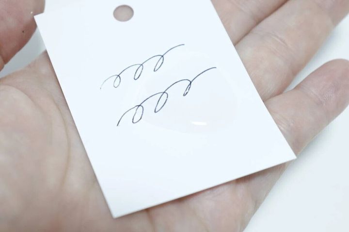 耐水単語帳の白い紙に水滴が落ち、ペンで書かれた文字がある