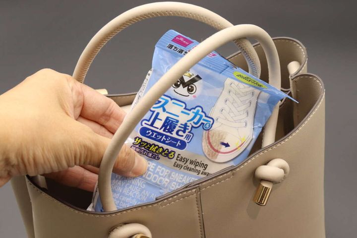 ベージュのハンドバッグにスニーカー＆上履きウェットシートを入れている