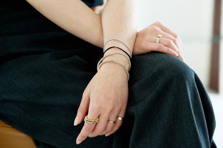 画像: 【PLOW】左手：リング（人差し指）Spring 6 Stone Ring Diamond -Gold-¥84,700、Spring 6 Stone Ring Onyx -Silver-¥55,000、リング（小指）DROP RING¥22,000、シルバーバングルSpring 4 Stone Bangle Onyx -Silver-¥56,100、Spring 4 Stone Bangle Turquoise -Silver-¥56,100、コードブレスレットPure Silk Bracelet 1 Diamond - Silver -各¥36,300、右手：リングHorseshoe Ring -Silver-¥22,000 plow-jewelry.jp