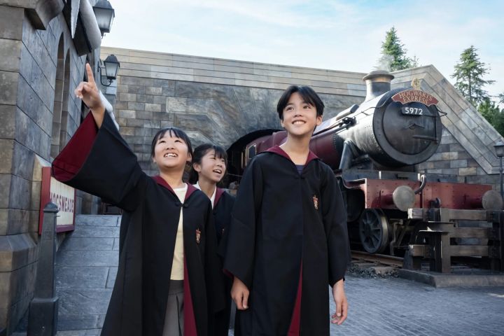 ホグワーツ特急の前で盛り上がるローブ姿の3人