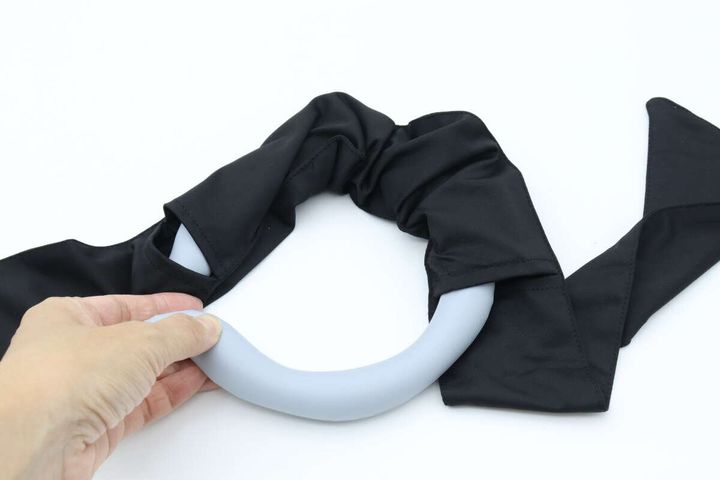女性の手がクールネックバンドをスカーフに通している