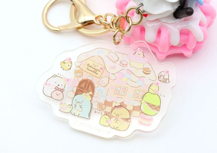 お菓子の家にすみっコぐらしのキャラクターたちが集まるデザインのアクリルキーホルダー