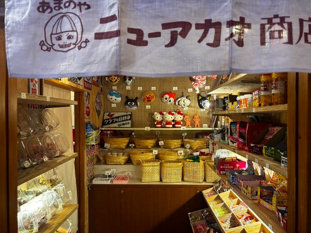 駄菓子屋の店内、お面やお菓子が並ぶ商品棚