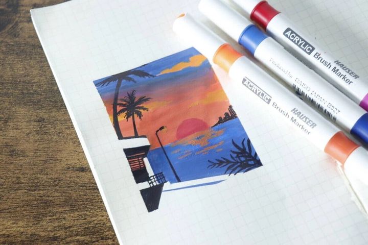 アクリルブラシマーカーで描かれた夕焼けの風景イラストとペン