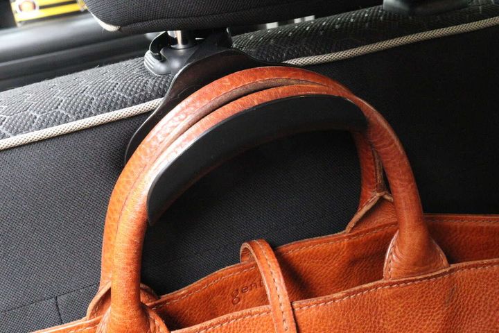 車用バッグフックに茶色い革のバッグが掛けられている様子