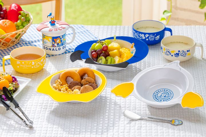 プレートやカップを食卓に並べたドナルドダックグッズ使用イメージ