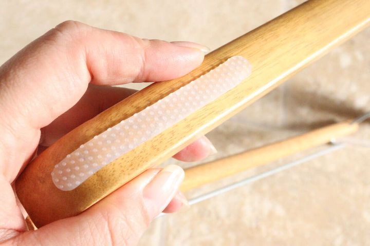 木製ハンガーの肩部分に半透明の滑り止めシリコーンシールを貼り付けている