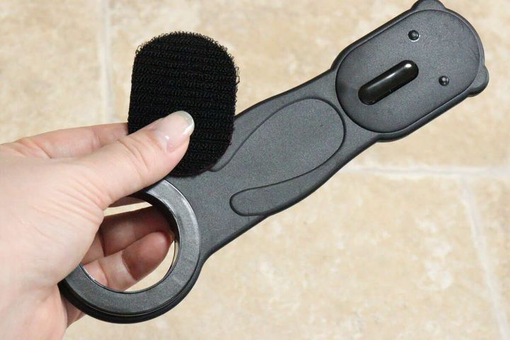 女性がスマホスタンド本体に面ファスナーを貼り付けている