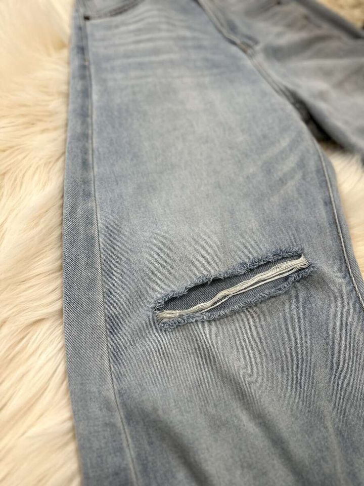淡いブルーのカーブデニムの膝部分にあるスリットのアップ