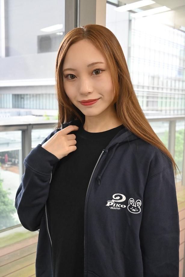 18歳のときに誕生したキャラクター「うさーや」と「PIKO KAILA」のブランドロゴが仲良く並ぶデザインのパーカーを着用