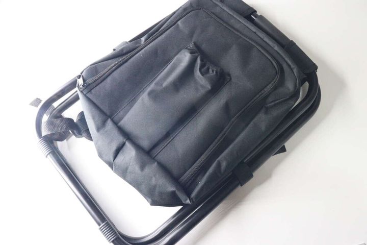 黒い折りたたみイスとリュックが一体化した商品を斜め上から撮影