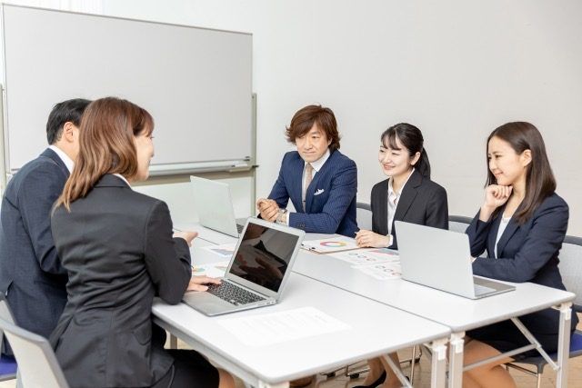 会議室で話し合う人たち